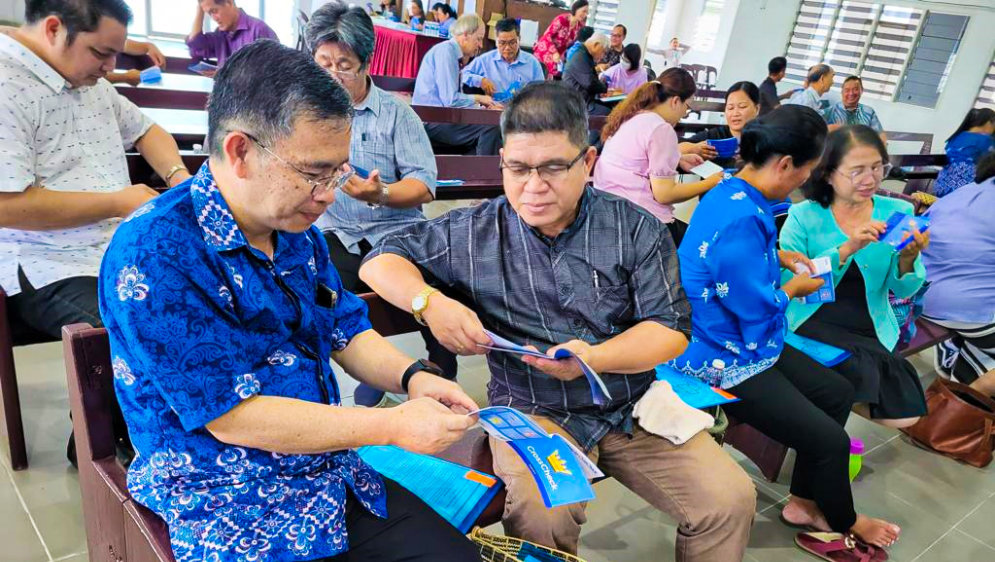 People practicing using the CrossCheck booklet